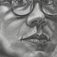 Greyscale portrait of a face, wearing glasses, and looking at the viewer