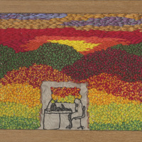 Textile landscape behind a figure sitting at a desk